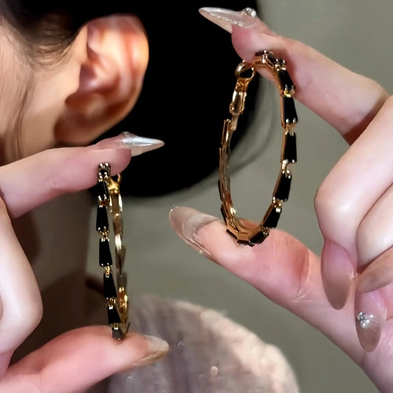 Angled view of the 14K Gold-Plated Black Zircon Hoop Earrings