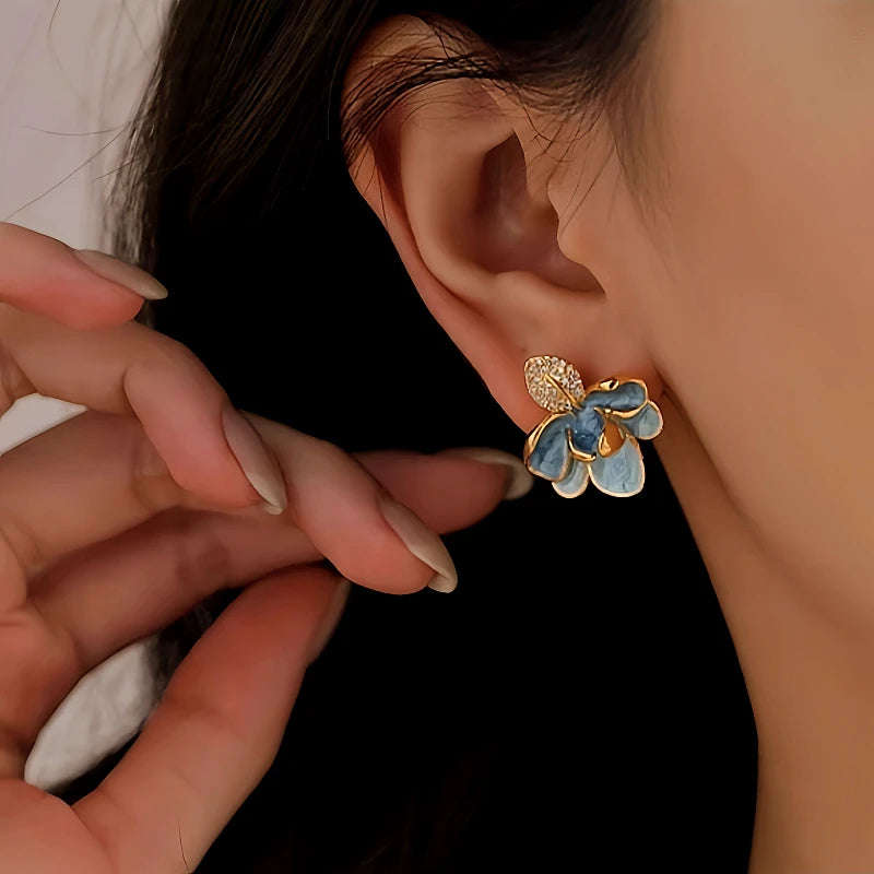 Angled view of the 14K Gold-Plated Blue Camellia Pearl Earrings