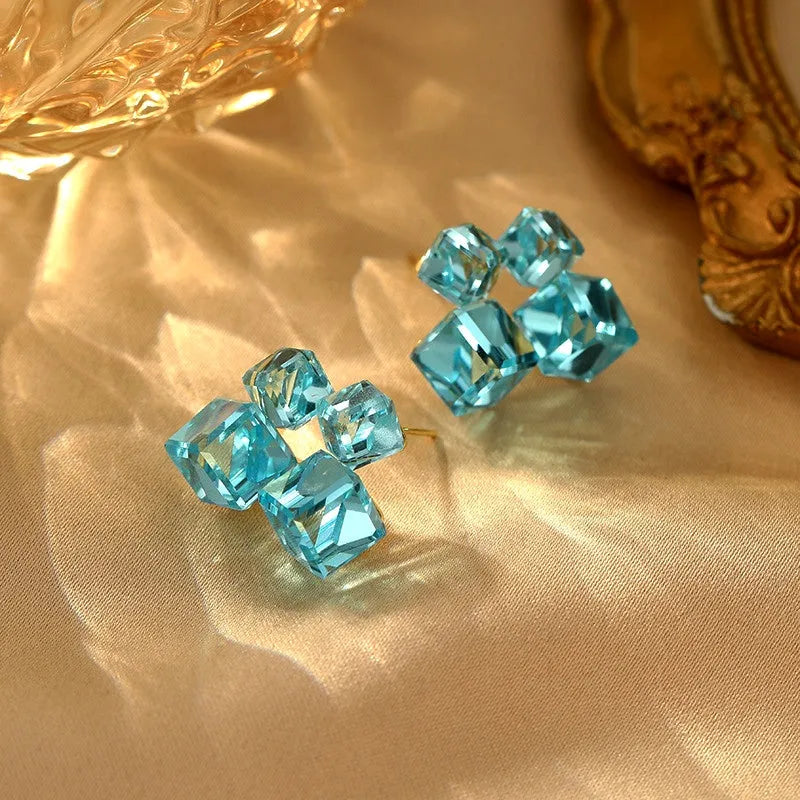 Angled view of the 14K Gold-Plated Blue Crystal Stud Earrings
