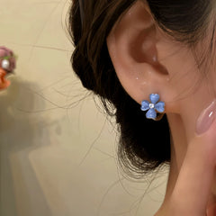 Close-up detail of the sparkling zircons and plating on the Four-Leaf Clover Earrings