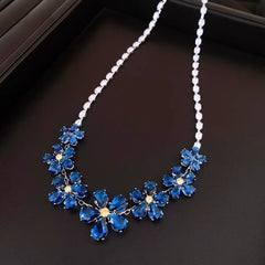Detailed view of the 14K Gold-Plated Blue Zircon Diamond Flower Necklace And Earrings Set chain and pendant