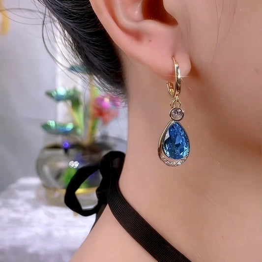 Model showcasing the dangle and style of the 14K Gold-Plated Blue Zircon Diamond Water Drop Earrings