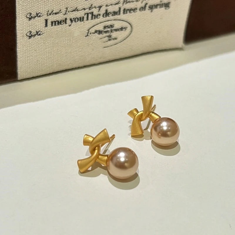 Angled view of the 14K Gold-Plated Bow Bead Earrings