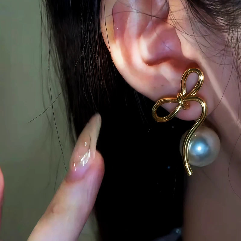 Close-up detail of the sparkling zircons and plating on the Bow Pearl Earrings