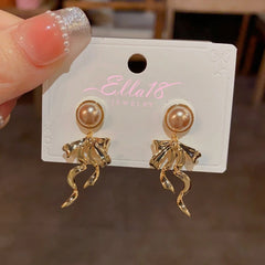Angled view of the 14K Gold-Plated Bow Tassel Earrings