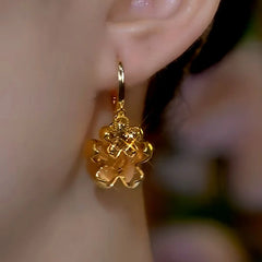 Model showcasing the dangle and style of the 14K Gold-Plated Brown Crystal Earrings
