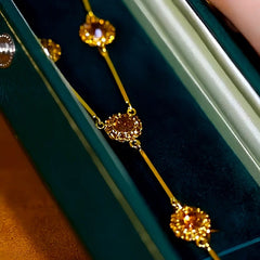 Detailed view of the 14K Gold-Plated Brown Crystal Tassel Necklace chain and pendant