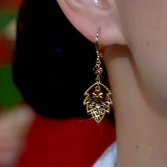 Model showcasing the dangle and style of the 14K Gold-Plated Brown Diamond Leaf Earrings