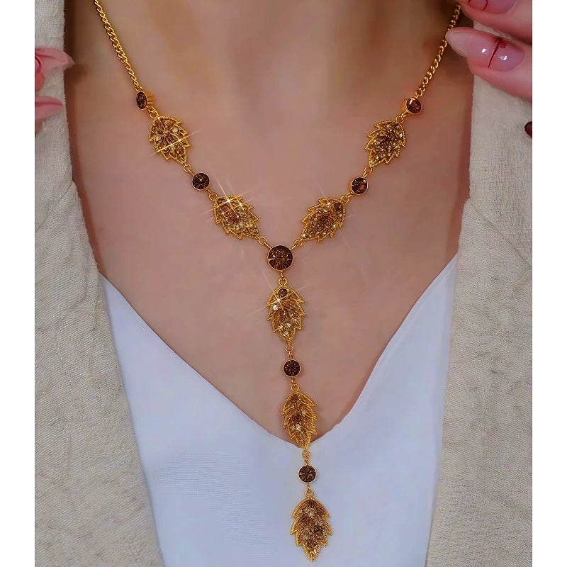 14K Gold-Plated Brown Diamond Leaf Tassel Earrings worn to showcase its length and pendant detail