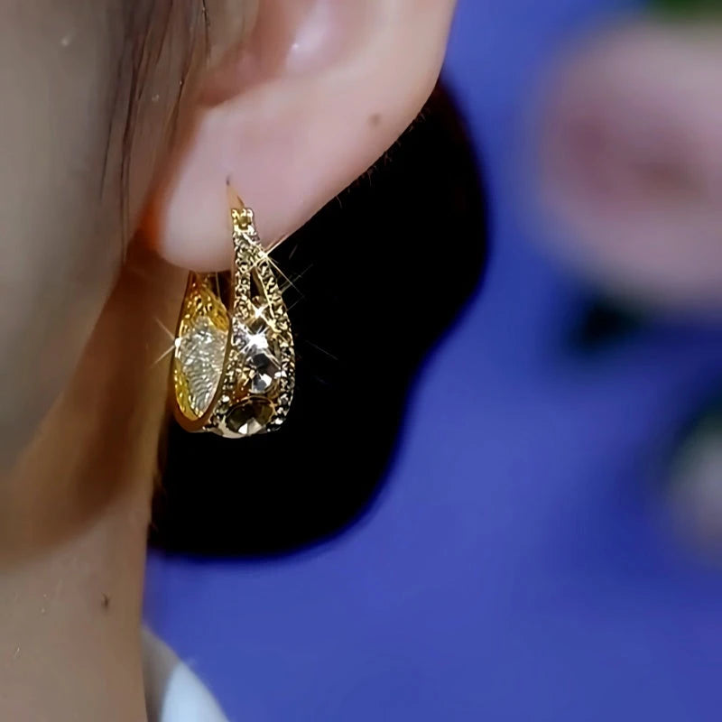 Model showcasing the dangle and style of the 14K Gold-Plated Brown Diamond Mesh Water Drop Earrings