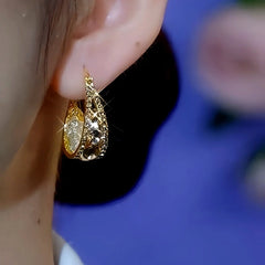 Model showcasing the dangle and style of the 14K Gold-Plated Brown Diamond Mesh Water Drop Earrings