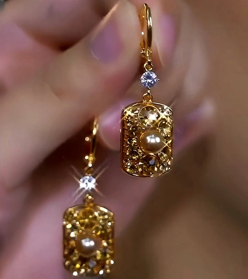 Close-up detail of the sparkling zircons and plating on the gold pearl earrings