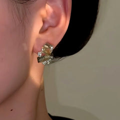 Close-up detail of the sparkling zircons and plating on the Cube Stud Earrings