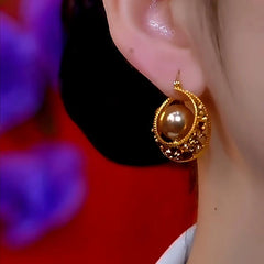 Model showcasing the dangle and style of the 14K Gold-Plated Brown Zircon Pearl Earrings
