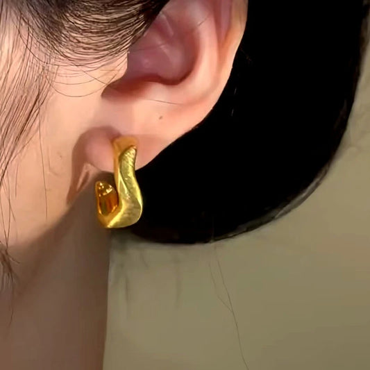 Model showcasing the dangle and style of the 14K Gold-Plated Brushed Geometric C-Shaped Earrings