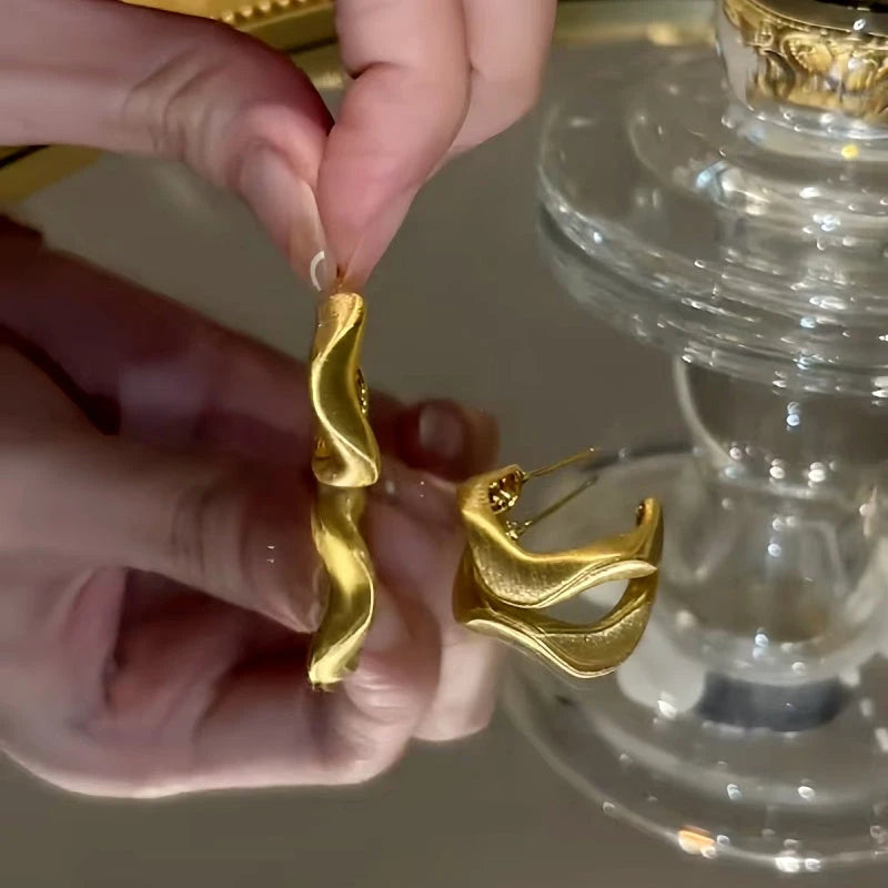 Close-up detail of the sparkling zircons and plating on the Geometric C-Shaped Earrings