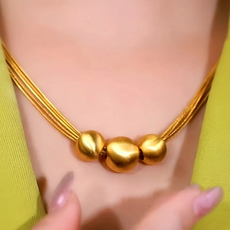 Close-up of the pendant and clasp on the Ball Necklace