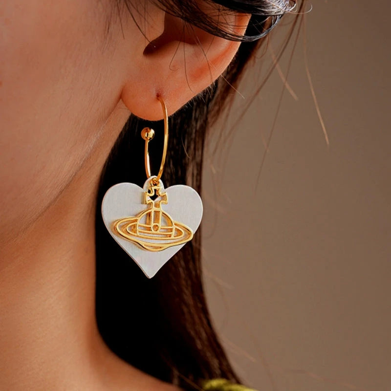Angled view of the 14K Gold-Plated Brushed Heart Saturn Earrings