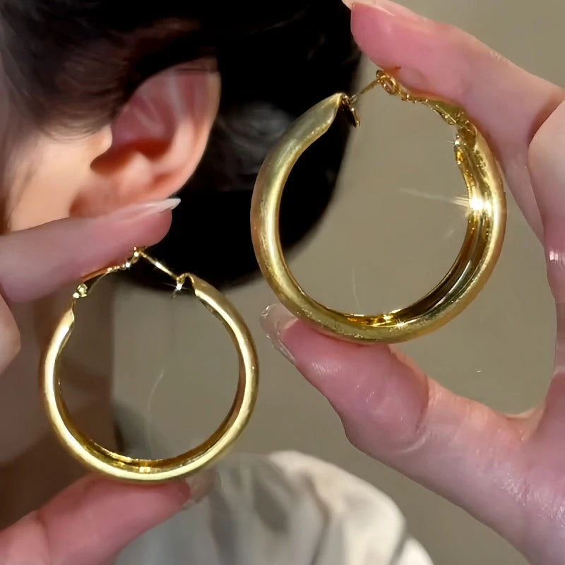 Angled view of the 14K Gold-Plated Brushed Hoop Earrings