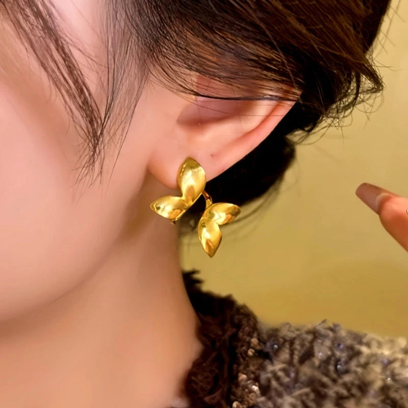 Model showcasing the dangle and style of the 14K Gold-Plated Butterfly Earrings