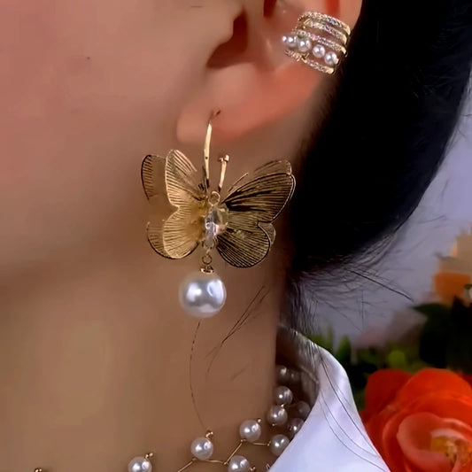 Model showcasing the dangle and style of the 14K Gold-Plated Butterfly Pearl Earrings