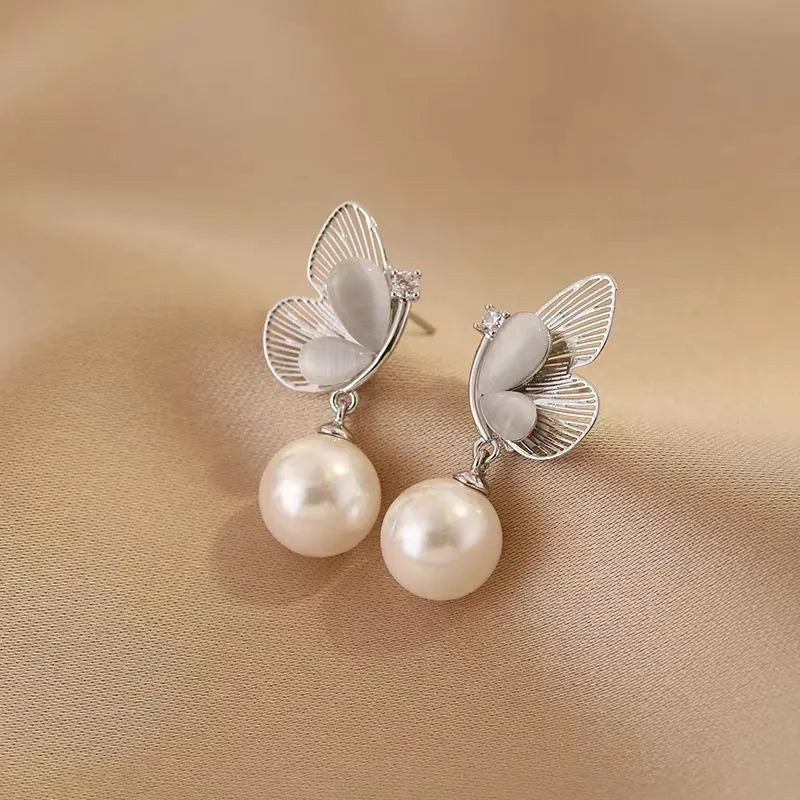 Close-up detail of the sparkling zircons and plating on the Butterfly Pearl Earrings