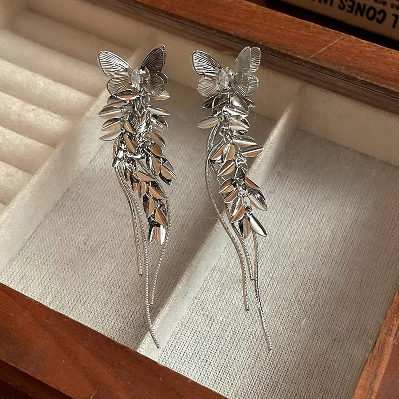 Angled view of the 14K Gold-Plated Butterfly Tassel Earrings