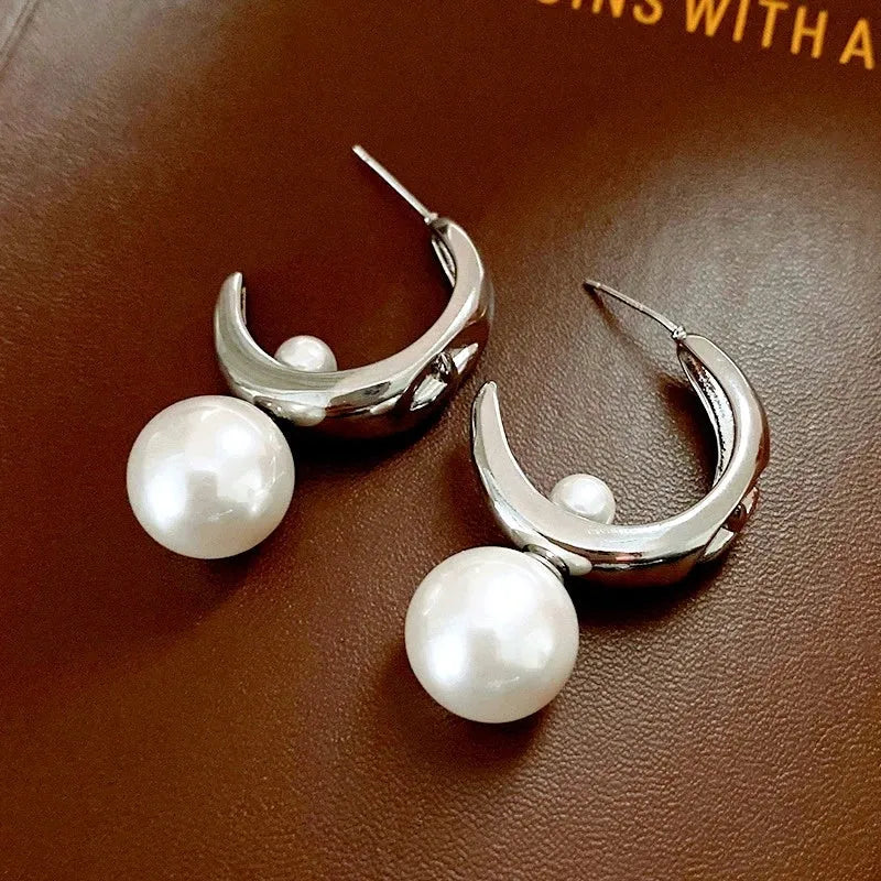 Model showcasing the dangle and style of the 14K Gold-Plated C-Shaped Bead Earrings