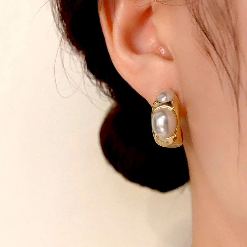 Model showcasing the dangle and style of the 14K Gold-Plated C-Shaped Pearl Earrings