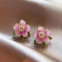 Model showcasing the dangle and style of the 14K Gold-Plated Camellia Crystal Earrings