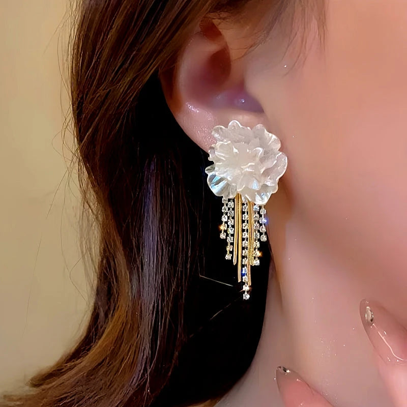 Model showcasing the dangle and style of the 14K Gold-Plated Camellia Tassel Earrings