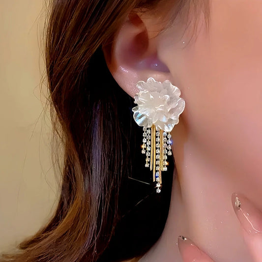 Model showcasing the dangle and style of the 14K Gold-Plated Camellia Tassel Earrings