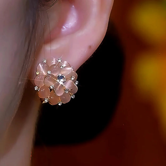 Model showcasing the dangle and style of the 14K Gold-Plated Cat's Eye Flower Bouquet Stud Earrings