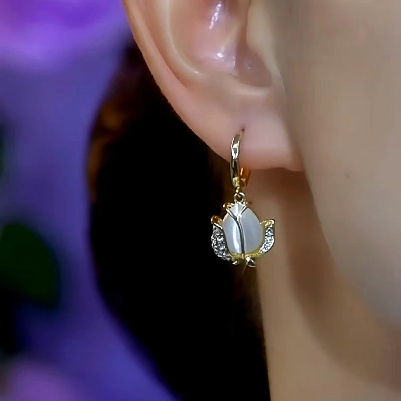 Model showcasing the dangle and style of the 14K Gold-Plated Cat's Eye Flower Earrings