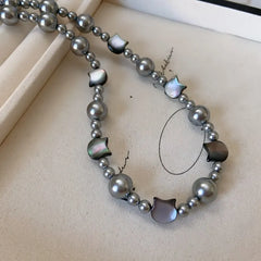 Styling the 14K Gold-Plated Cat's Eye Stone Cat Pearl Necklace with a beautiful outfit