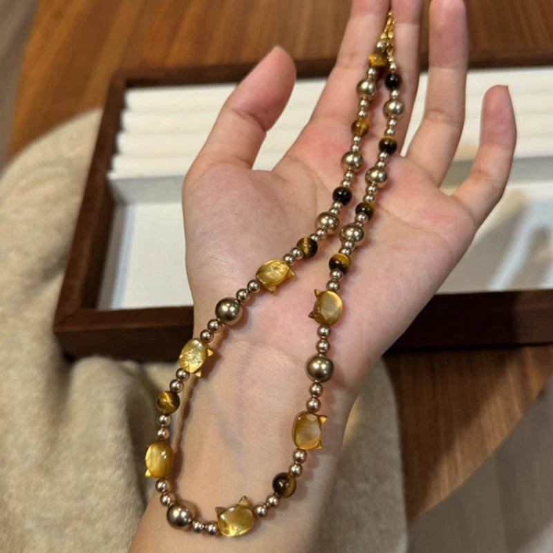 Detailed view of the 14K Gold-Plated Cat's Eye Stone Cat Pearl Necklace chain and pendant