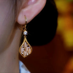 Close-up detail of the sparkling zircons and plating on the Cat's Eye Diamond Earrings
