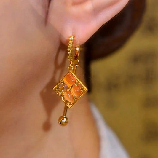 Model showcasing the dangle and style of the 14K Gold-Plated Cat's Eye Stone Diamond Water Drop Earrings