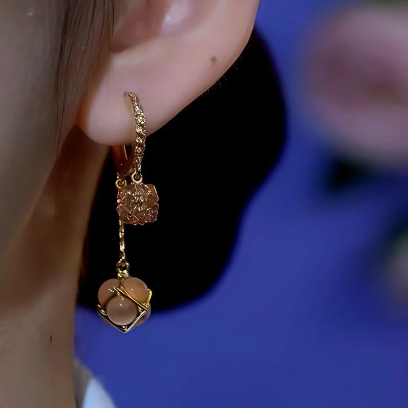 Model showcasing the dangle and style of the 14K Gold-Plated Cat's Eye Stone Earrings