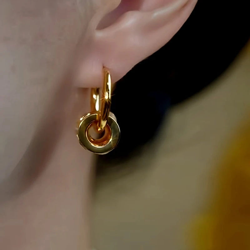 Model showcasing the dangle and style of the 14K Gold-Plated Cat's Eye Stone Hoop Earrings