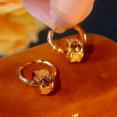 Angled view of the 14K Gold-Plated Cat's Eye Stone Hoop Earrings