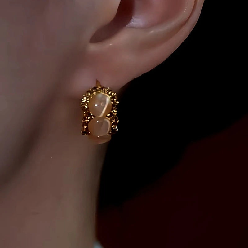 Close-up detail of the sparkling zircons and plating on the Cat's Eye Hoop Earrings