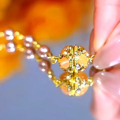 Detailed view of the 14K Gold-Plated Cat's Eye Stone Magnetic Pearl Necklace chain and pendant