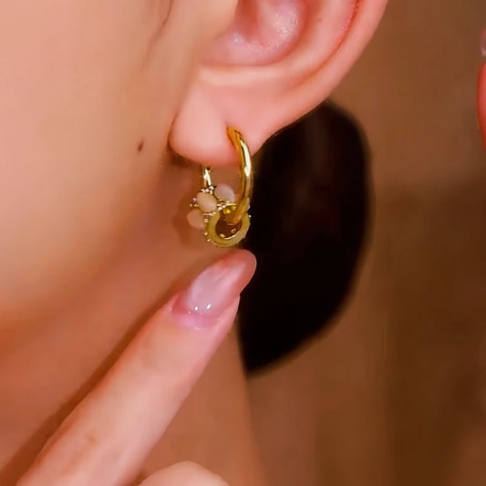 Model showcasing the dangle and style of the 14K Gold-Plated Cat's Eye Stone Rings Hoop Earrings