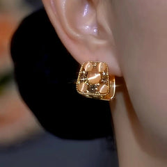 Model showcasing the dangle and style of the 14K Gold-Plated Cat's Eye Stone Zircon Diamond Double-Sided Earrings