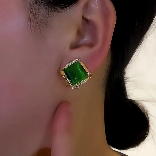 Model showcasing the dangle and style of the 14K Gold-Plated Cat's Eye Stone Zircon Diamond Stud Earrings