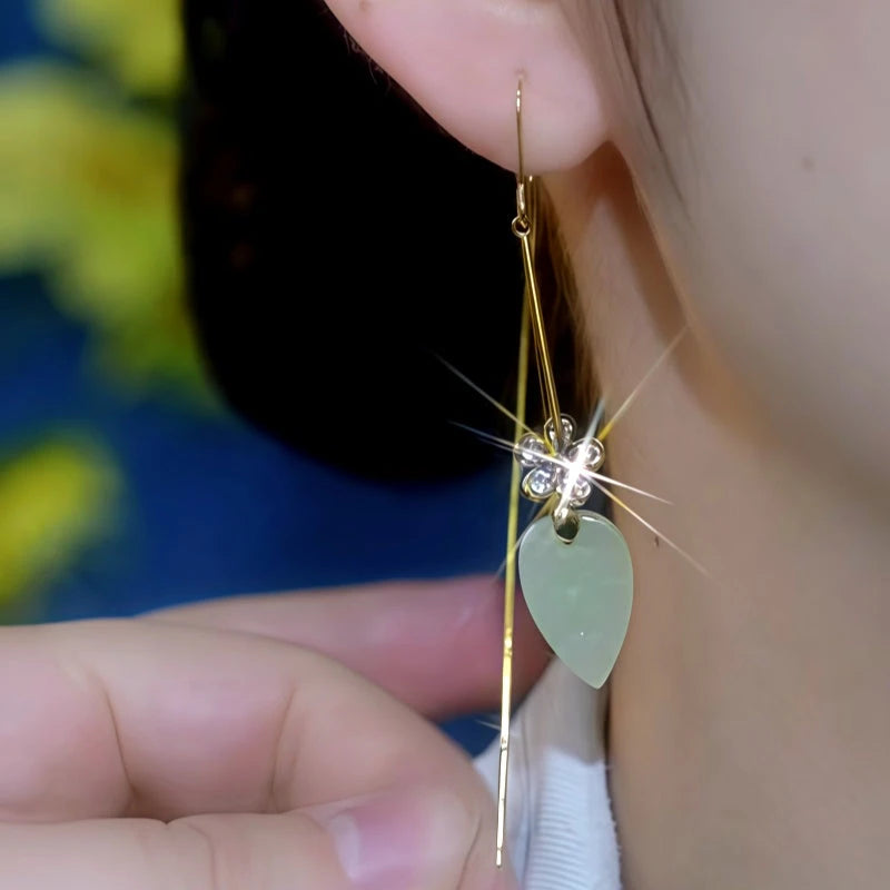 Model showcasing the dangle and style of the 14K Gold-Plated Cat's Eye Stone Zircon Flower Threader Earrings