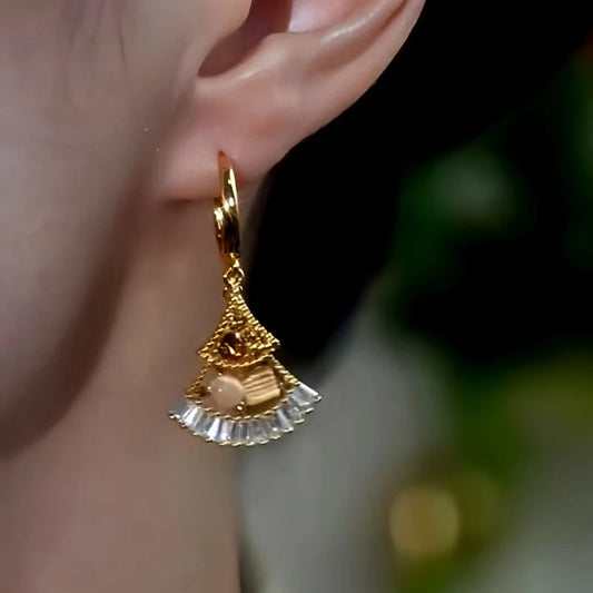 Model showcasing the dangle and style of the 14K Gold-Plated Cat's Eye Zircon Fan-Shaped Earrings