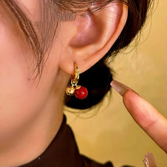 Model showcasing the dangle and style of the 14K Gold-Plated Cherry Bead Earrings