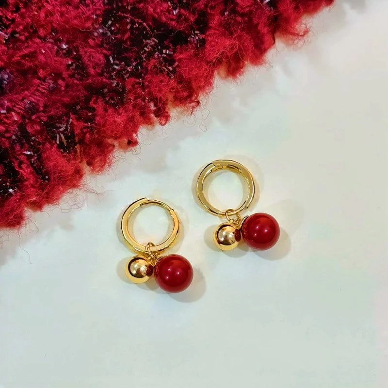 Angled view of the 14K Gold-Plated Cherry Bead Earrings